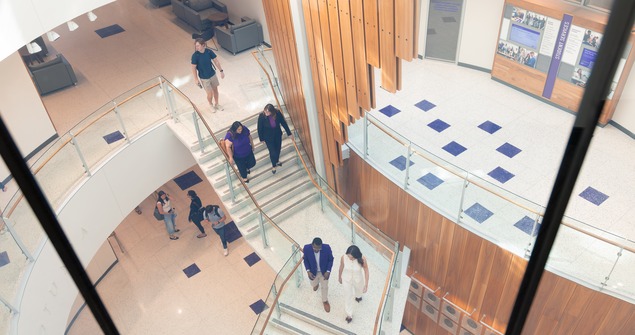 Bird's eye view of students walking and talking inside Neeley building