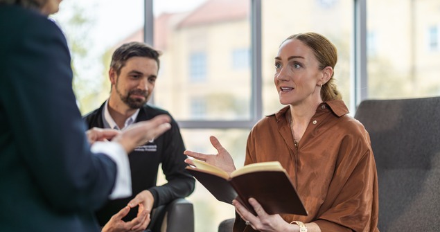 Students and faculty meeting in Neeley