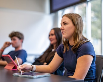 Student listening and taking notes in class
