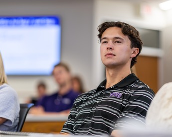 Student engaged in class presentation in Neeley lecture hall